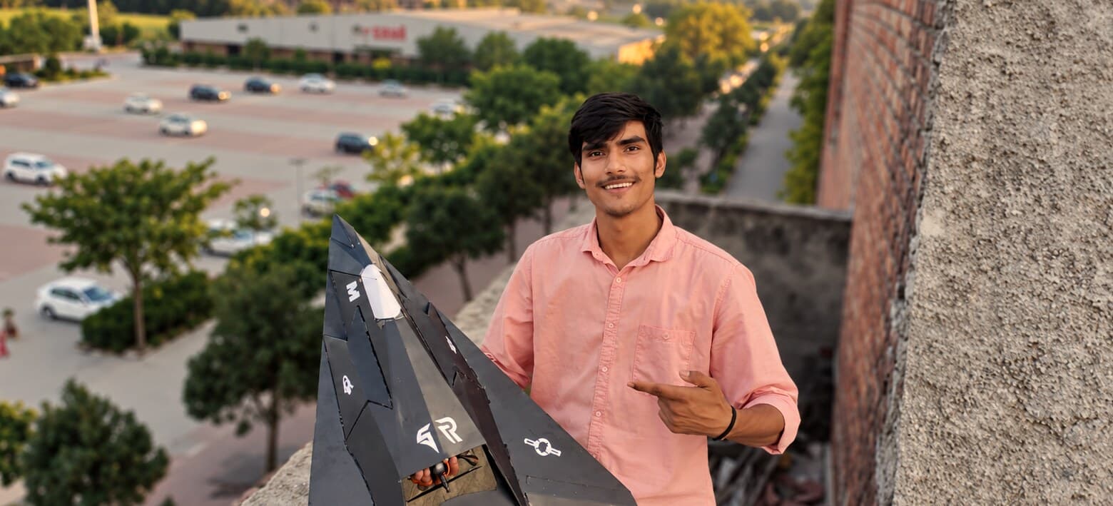 Vinay Tiwari holding the F-117 Nighthawk model aircraft he built
